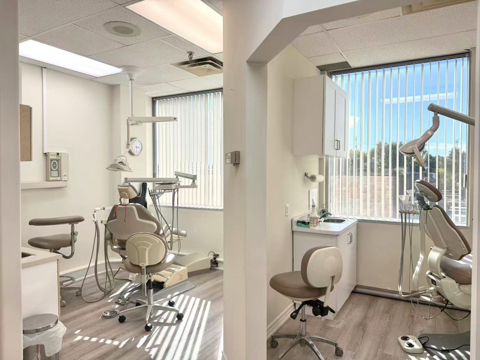Two bright treatment rooms at Highway 7 Emergency Dental, with dental chairs beside large windows